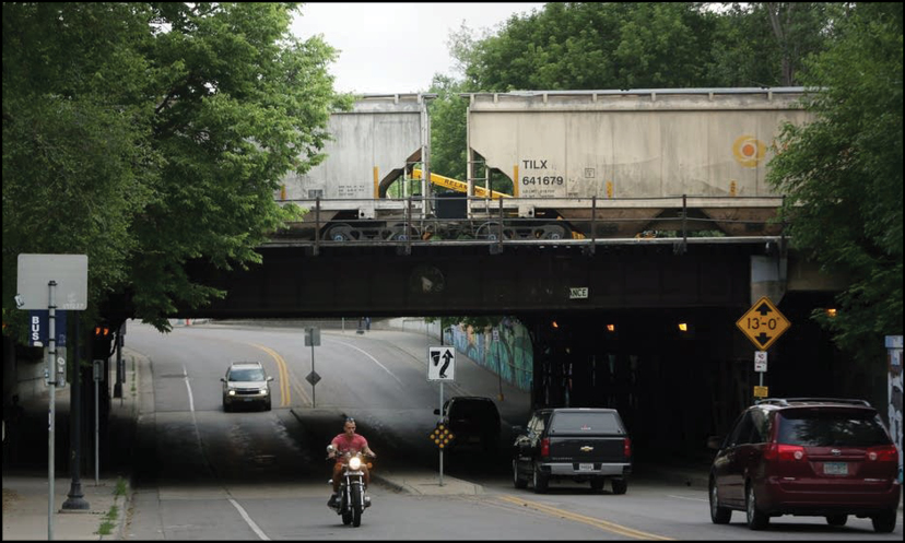 Vehicles traveling under a railroad bridge