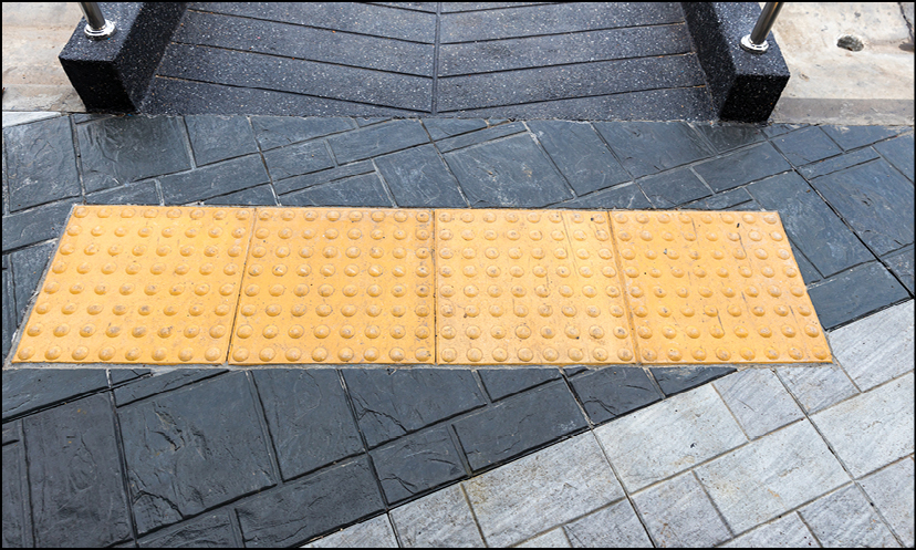 Tactile yellow pedestrian crossing indicator